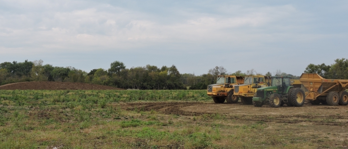 Tractors and Bulldozers in dirt field